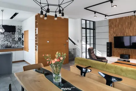 Wnętrze salonu w stylu industrialnym z minimalistycznym wystrojem, drewnianą ścianą i nowoczesnymi akcentami.
