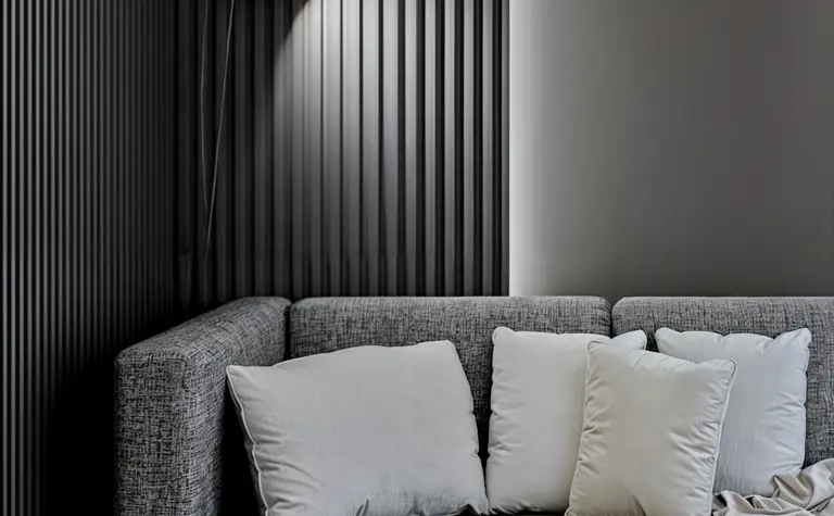 Wnętrze nowoczesnego salonu z minimalistycznym narożnikiem i oświetleniem w stylu skandynawskim.