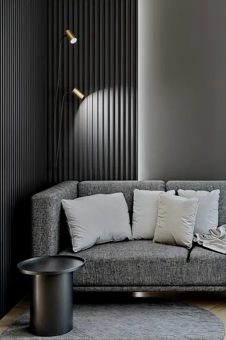 Wnętrze nowoczesnego salonu z minimalistycznym narożnikiem i oświetleniem w stylu skandynawskim.
