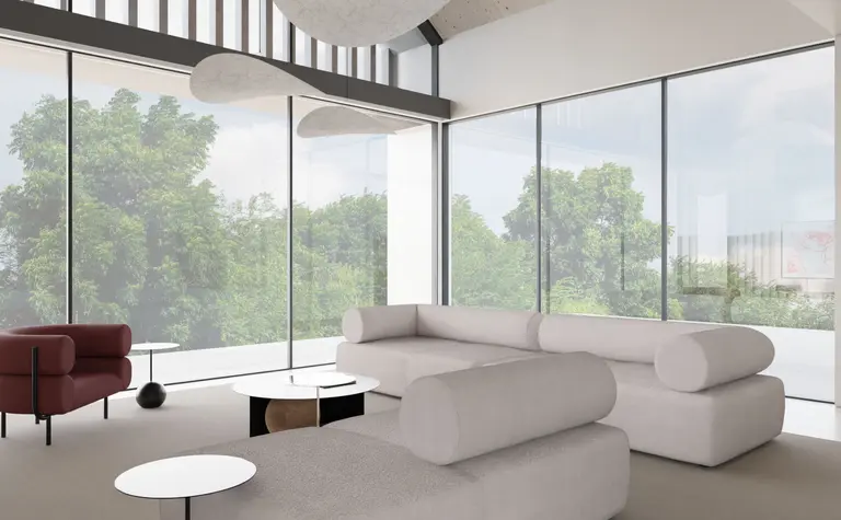 Wnętrze salonu z minimalistycznym designem, nowoczesnymi meblami i dużymi oknami.