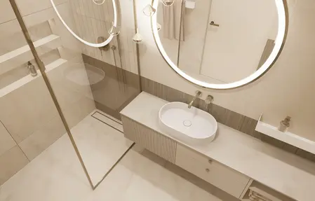 Nowoczesna łazienka z minimalistycznym wystrojem, okrągłymi lustrami i elegancką umywalką.