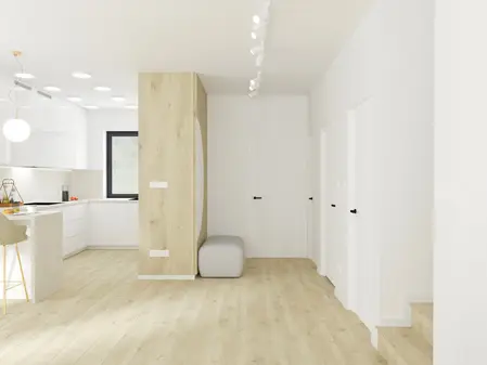 Nowoczesna kuchnia z minimalistycznym wystrojem, białymi meblami i drewnianą podłogą.