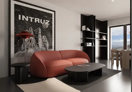 Wnętrze nowoczesnego salonu z czerwoną sofą i czarnymi akcentami.