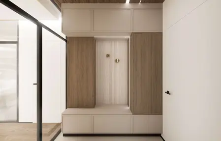 Minimalistyczny przedpokój z drewnianymi szafkami i jasnym tłem, nowoczesny design.