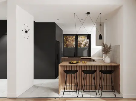 Wnętrze nowoczesnej kuchni z drewnianym blatem, czarnymi lampami i minimalistycznym designem.