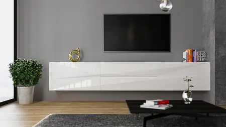 Nowoczesne wnętrze salonu z białą szafką, telewizorem i rośliną.