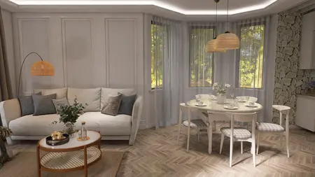 Wnętrze salonu w stylu prowansalskim z jasną sofą, okrągłym stołem i drewnianą podłogą.