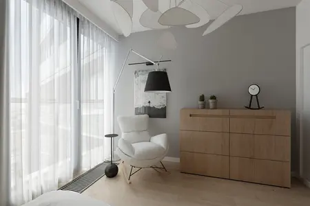 Styl minimalistyczny wnętrza z białym fotelem i drewnianą komodą.