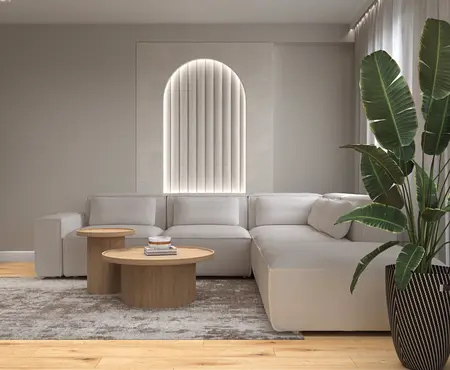 Nowoczesny salon w stylu boho z jasną sofą i rośliną.