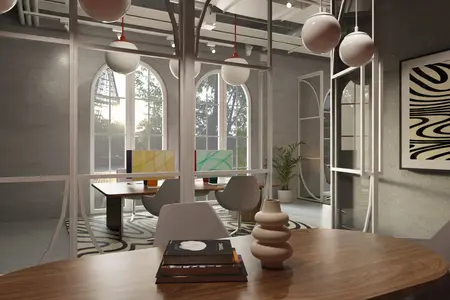 Wnętrze biura z minimalistycznym designem, dużymi oknami, roślinami oraz nowoczesnym wyposażeniem.