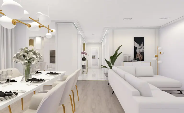 Wnętrze salonu z białą sofą, eleganckim oświetleniem i roślinami.
