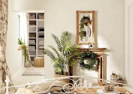 Wnętrze w stylu boho z roślinami, drewnianymi detalami i rustykalnym kominkiem