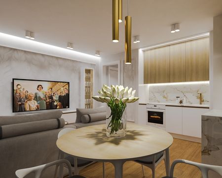 Wnętrze kuchni z białymi meblami, drewnianym blatem i kwiatami, styl quiet luxury.