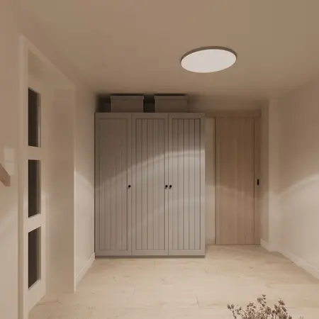 Minimalistyczna garderoba z szarymi szafkami i jasną podłogą, nowoczesne wnętrze.