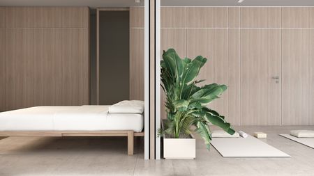 Wnętrze sypialni w stylu japandi i minimalistycznym z roślinami.