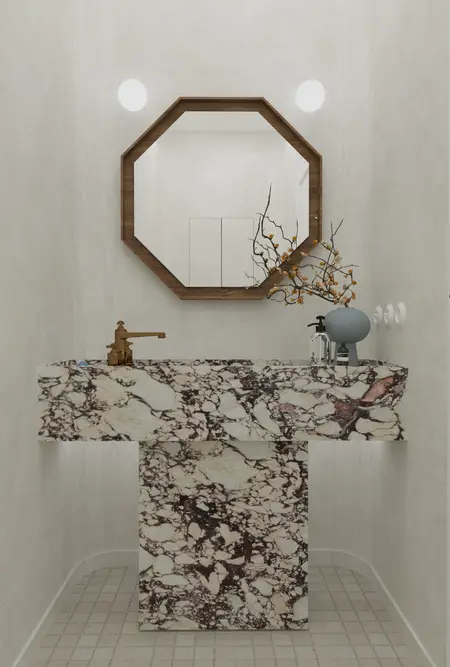 Nowoczesna łazienka z marmurową umywalką, lustrem w stylu art deco i minimalistycznymi akcentami.