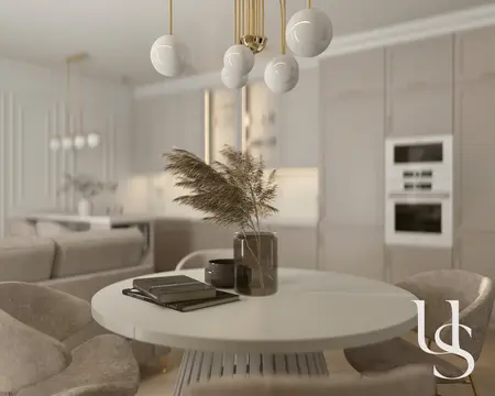 Jadalnia w stylu glamour z okrągłym stołem i eleganckimi krzesłami.