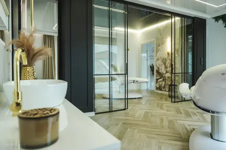 Nowoczesne wnętrze salonu z białymi meblami i złotymi akcentami, styl glamour.