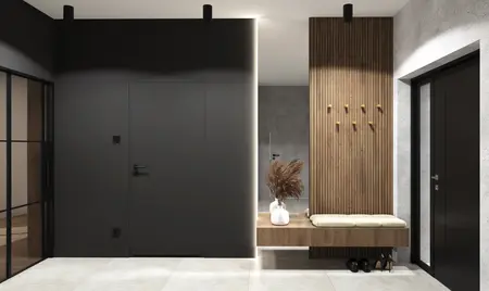 Przedpokój z ciemnymi ścianami, drewnianymi detalami i nowoczesnymi akcesoriami.