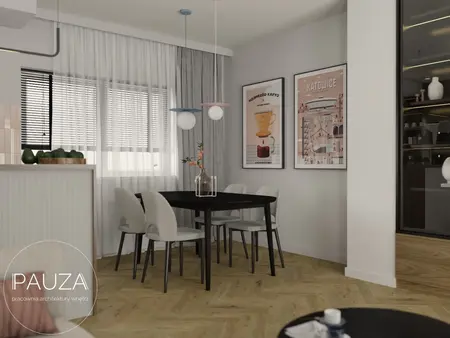 Wnętrze jadalni z czarnym stołem, jasnymi krzesłami i nowoczesnymi akcentami.