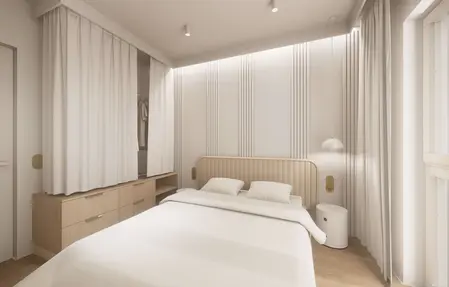 Sypialnia w stylu japandi z minimalistycznym wystrojem, białymi i drewnianymi elementami.