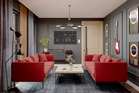 Wnętrze salonu w stylu eklektycznym i industrialnym z czerwonymi sofami i drewnianym stołem.