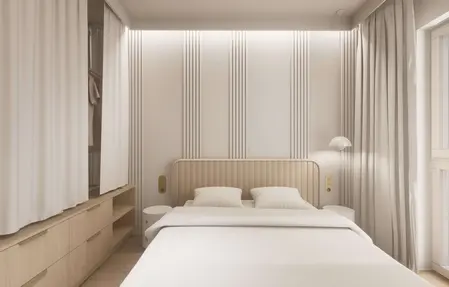 Minimalistyczna sypialnia w stylu japandi z jasnymi meblami i subtelnym oświetleniem.