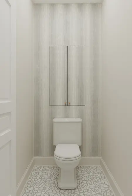 Toaleta w stylu art deco z białą ceramiką i mozaiką.