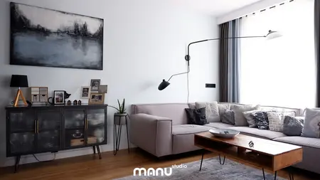 Wnętrze salonu z nowoczesnym oświetleniem i skandynawskimi meblami.