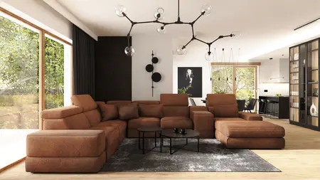 Wnętrze salonu z brązową sofą, industrialnymi i nowoczesnymi detalami.