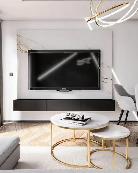 Wnętrze salonu z telewizorem, nowoczesnymi meblami i eleganckimi akcentami.