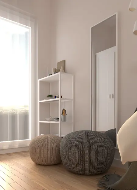 Wnętrze pokoju z białymi meblami, szarymi akcentami i minimalistycznym designem.