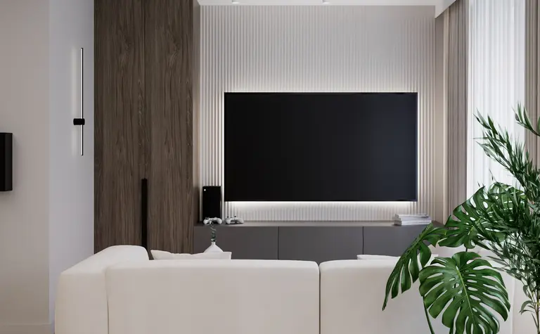 Wnętrze salonu w minimalistycznym stylu z białą sofą i roślinnością.