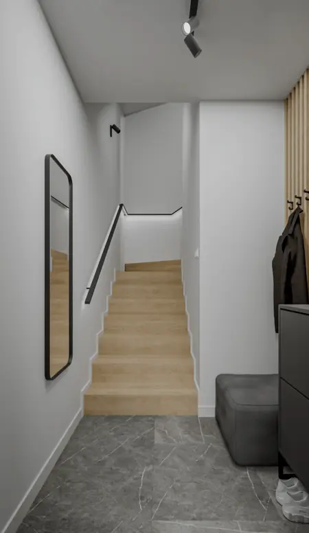 Przedpokój z minimalistycznym wystrojem, drewnianymi schodami i nowoczesnym lustrem.