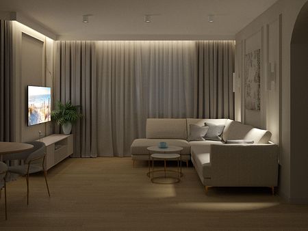 Wnętrze salonu w stylu quiet luxury z jasnymi meblami i eleganckim oświetleniem.