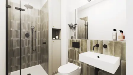 Wnętrze łazienki w stylu boho i minimalistycznym z szarymi kafelkami i białą umywalką.