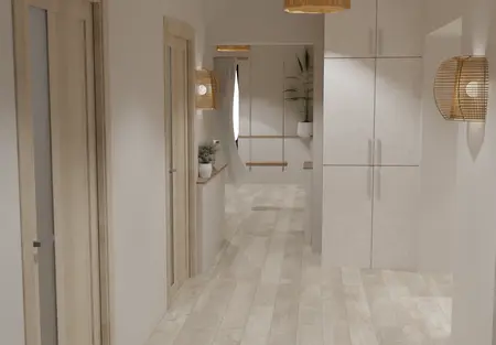 Przestronny przedpokój w naturalnych barwach z drewnianymi drzwiami, szafą wnękową oraz ozdobnymi lampami rattanowymi. Na końcu korytarza dekoracyjne rośliny.