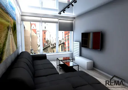 Wnętrze salonu z czarną sofą, szklanym stolikiem i nowoczesnym TV w stylu industrialnym.