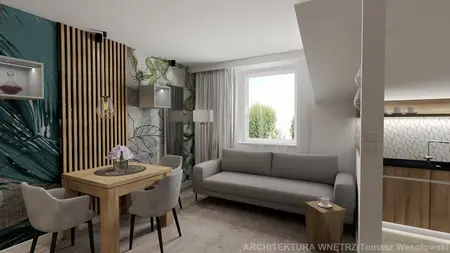 Wnętrze nowoczesnego salonu z drewnianym stołem, szarym sofą i roślinnymi akcentami.