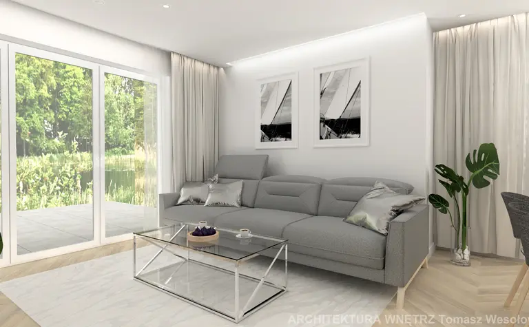 Nowoczesny salon z szarym narożnikiem, szklanym stolikiem i roślinami, minimalistyczny design.