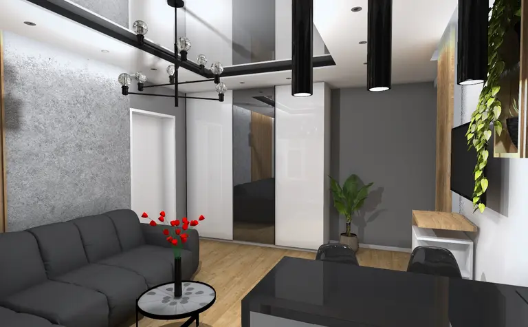 Wnętrze salonu w stylu industrialnym z czarną sofą, szarymi ścianami i rośliną.
