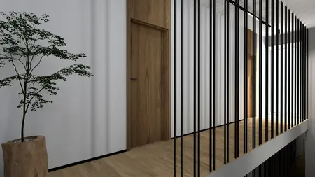 Korytarz z drewnianą podłogą, rośliną i stalowymi balustradami w nowoczesnym wnętrzu.