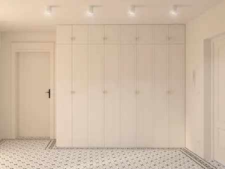 Przedpokój z minimalistycznymi szafkami i tradycyjnymi kafelkami.