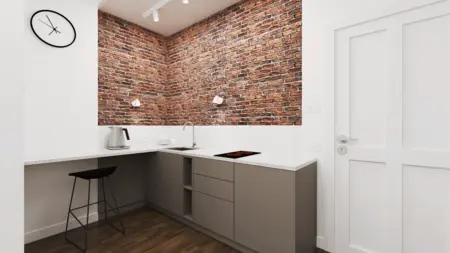 Kuchnia w stylu industrialnym z ceglaną ścianą i szarymi meblami.