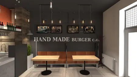 Wnętrze restauracji z industrialnym klimatem i drewnianymi meblami.
