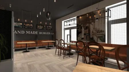 Interiors of a restaurant with industrial style, wooden furniture, and pendant lighting.