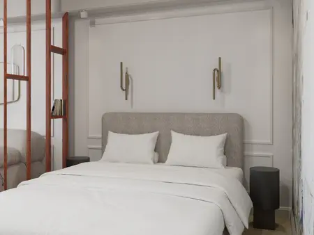 Sypialnia w stylu art deco i tradycyjnym z białym łóżkiem i dekoracyjną ścianą.
