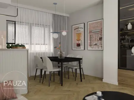 Wnętrze jadalni z czarnym stołem, jasnymi krzesłami i nowoczesnymi akcentami.