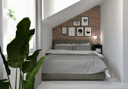 Sypialnia w stylu industrialnym i soft minimalizm z ceglaną ścianą i szarym łóżkiem.
