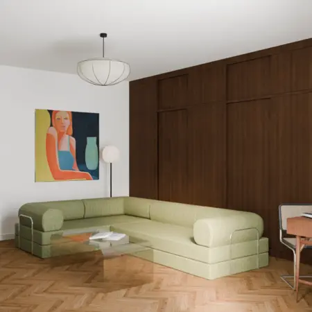 Wnętrze salonu z zieloną sofą, drewnianą ścianą i obrazem w stylu vintage.